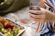 © Liliia Mykhalevych - Hand with a glass of red vine on picnic. close up. horizontal photo