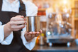© Monstar Studio - Closeup female hands are holding metal cup of aromatic coffee. Barista woman  prepared, brewed espresso, americano, latte cappuccino using professional machine in cafe, restaurant. Take away, to go.