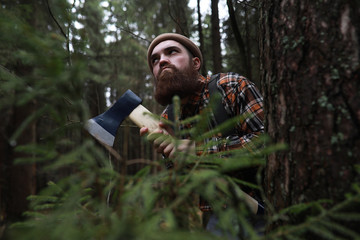 Wall Mural - A bearded lumberjack with a large ax