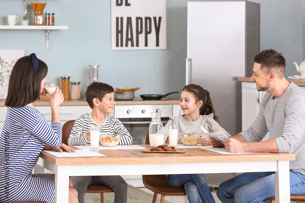 Family drinking milk during breakfast at home