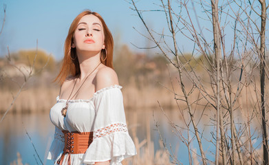 Wall Mural - Nature look, Medieval style of clothes, redhead woman in cotton vintage blouse, belt and skirt