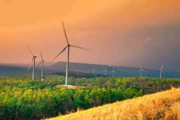 Natural blurred natural background, high angle viewpoint area, overlooking trees and mountains and large windmills,abundance of forests