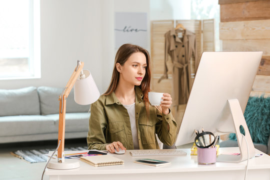 Young designer working on computer at home
