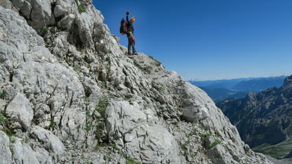 Wall Mural - Tourist with equipment on the via ferrata trail in the alps