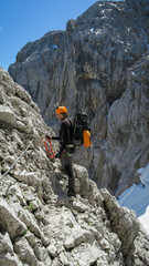 Wall Mural - Tourist with equipment on the via ferrata trail in the alps