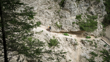 Wall Mural - Going through a difficult trail in the full inventory located in the gorge. Dolomites in the Alps.