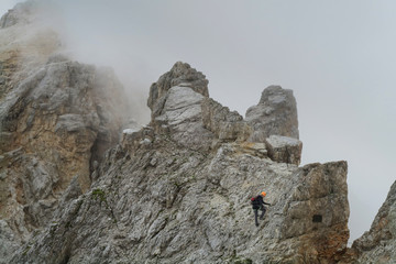 Wall Mural - Tourist with equipment on the via ferrata trail in the alps