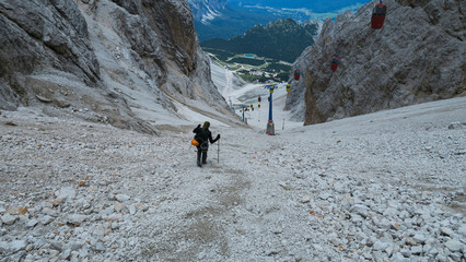 Wall Mural - Tourist from the inventory trail in the gully with the gondola lift to Forcella Staunies, Monte Cristallo group, Dolomites, Italy