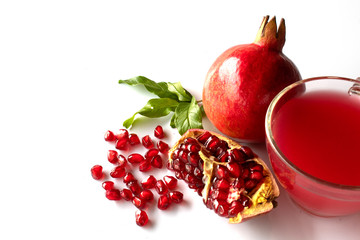 Wall Mural - pomegranate with leaves and juice isolated on white background