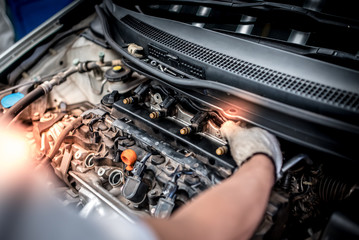 Wall Mural - Auto technicians are checking car injection systems using diagnostic and repair tools in the engine room for motor vehicles.