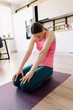 © arthurhidden - Attractive woman practicing yoga at home, stretching