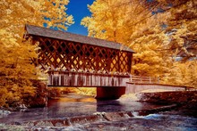 Beautiful Wooden Bridge Over The River Surrounded By Trees Shot In Infrared