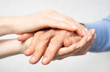 Young Hands Hold Old Hands. Support For The Elderly Concept.