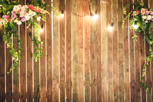 Wooden Wall With Lamps And Flowers. Copy Space