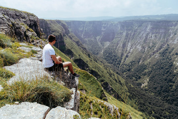 Male on top of a large mountain having a panoramic view towards a canyon Salto de Nervion. Burgos. Spain