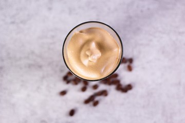 Wall Mural - Overhead shot of a caramel smoothie surrounded by coffee beans