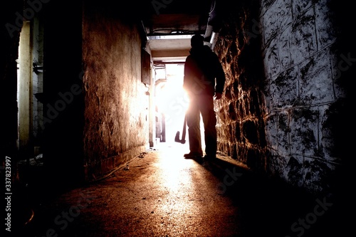 Silhouette of Man holding Axe. Hatchet in Arm in dark Hallway. Scary homicide scenes