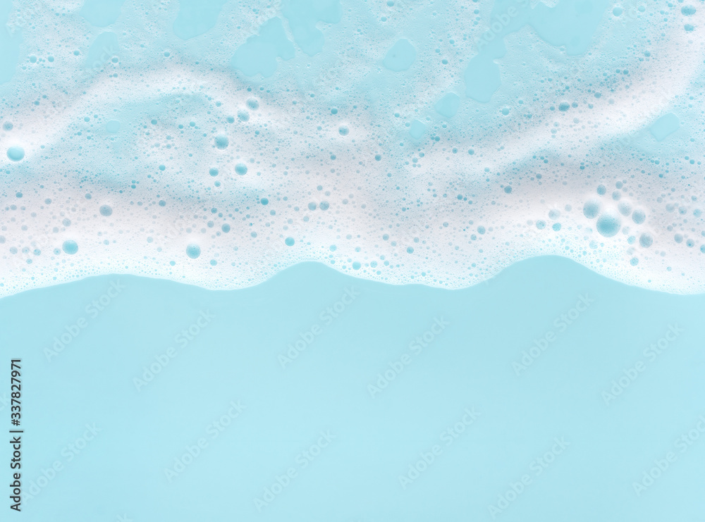 border of soap foam on turquoise background, with copy space - obrazy, fototapety, plakaty 
