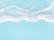 canvas print picture - border of soap foam on turquoise background, with copy space