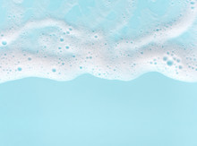 Border Of Soap Foam On Turquoise Background, With Copy Space