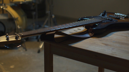 The guitar lies on the table. Sliding