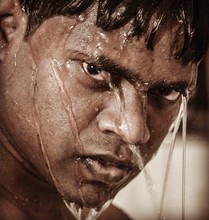 Close-up Of Water Flowing On Angry Man Face