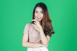 © tuaindeed - Portrait of beauty cute young Asian woman smiling over green isolated background. Skin care concept.