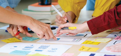 Wall Mural - brainstorm planing creative asian teamwork, close up of hands mobile phone app developer team meetin