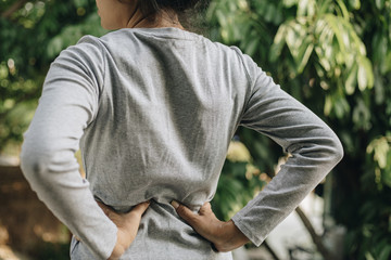 Wall Mural - Young asian woman feel pain on her back, health care concept.