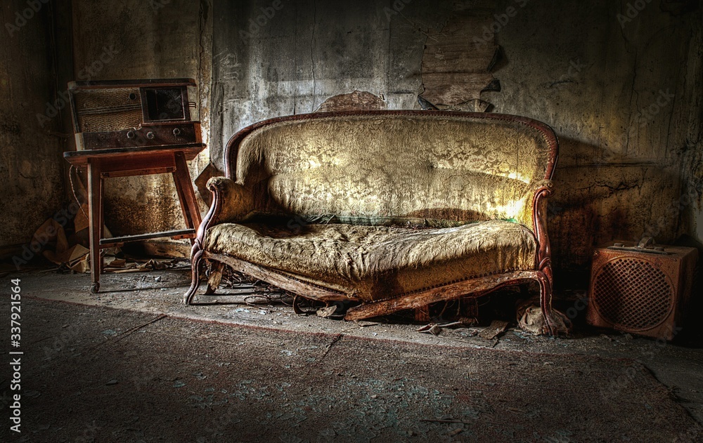 Damaged Sofa In Abandoned Room - obrazy, fototapety, plakaty 