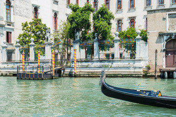 Wall Mural - Ancient buildings and boats in the channel in Venice