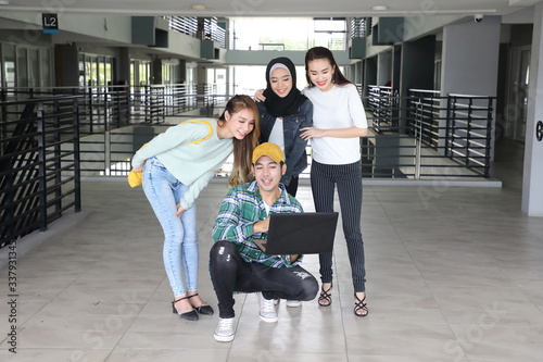 Cuadros en Lienzo Young asian malay chinese man woman indoor stair corridor campus book file folde