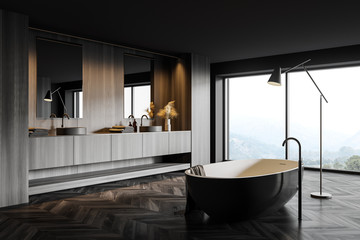 Dark wooden bathroom corner with tub and sink