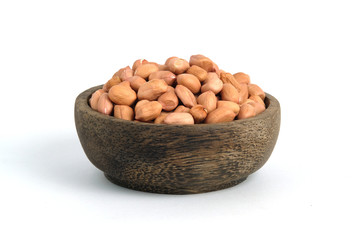 Closeup raw peanuts on wooden bowl isolated white background