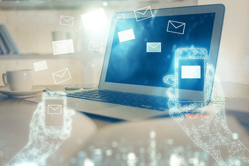 Desktop computer background in office and flying envelops hologram drawing. Multi exposure. Electronic mail concept.