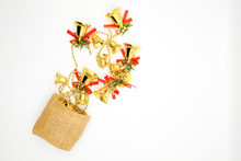Directly Above Shot Of Bells In Burlap Bag On White Background
