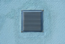 Square Metal Ventilation Grate In A Blue Wall, Close View, Delivers Fresh Air And Cools