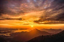 High Angle View Of A Breathtaking Sunset Scenery In The Golden Cloudy Sky Over The Hills