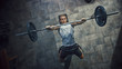 © Gorodenkoff - Top View of Professional Athlete Doing Bench Press Workout with a Barbell in the Hardcore Gym. Muscular and Athletic Bodybuilder Doing Barbell Exercise.
