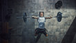 © Gorodenkoff - Top View of Professional Athlete Doing Bench Press Workout with a Barbell in the Hardcore Gym. Muscular and Athletic Bodybuilder Doing Barbell Exercise.