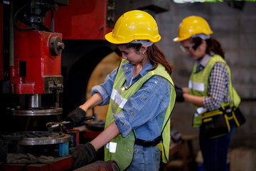 Wall Mural - Pretty woman workers or technician are working with machine in factory. Concept of good process to get better industrial business.