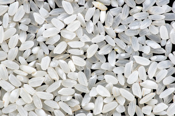 rice and round grain peeled seeds on a black background top view