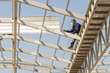 © Antony - Man working on roof metal sheet on Light steel Truss and Frame construction.