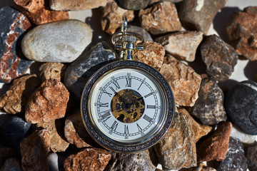 Vintage pocket watch on the rocks