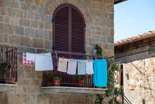 Balcony With Drying Linen On A Sunny Summer Day In Tuscany