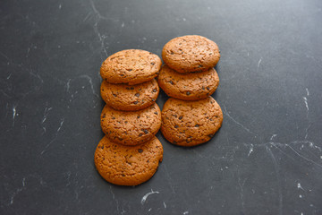 Wall Mural - traditional cookies with chocolate chips on a dark background