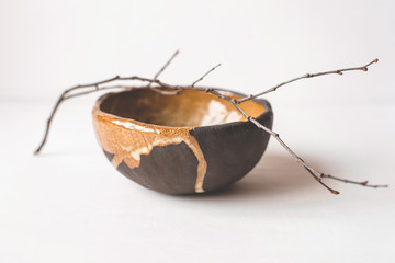 Handmade ceramics in the style of wabi sabi. Brown clay bowl with an abstract pattern.