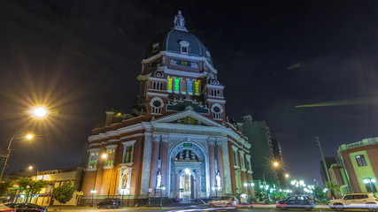 Exterior of the Immaculate Heart of Mary Church illuminated at night timelapse hyperlapse. Lima, Peru