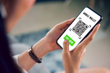 woman using smartphone for qr code payment mobile banking on application wallet.