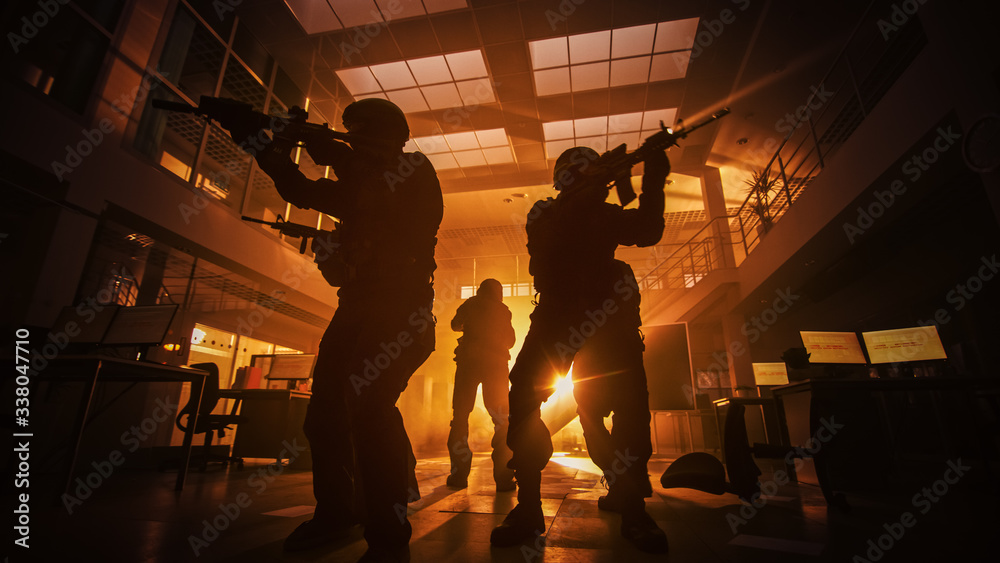 Masked Squad of Armed SWAT Police Officers Move in a Hall of a Dark ...